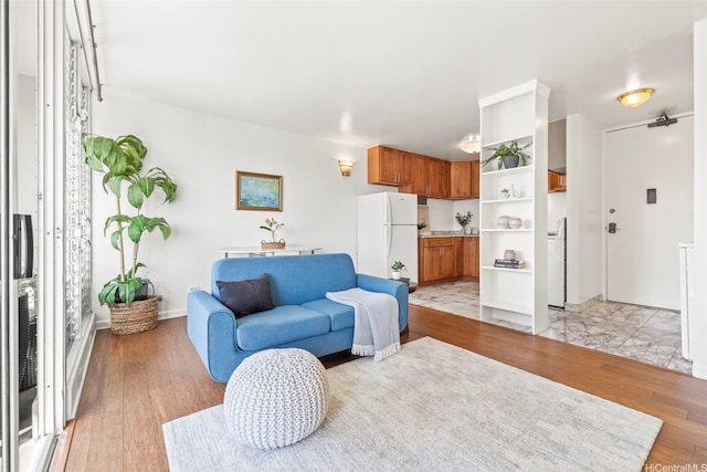 2754 Kuilei St Unit 2002, Honolulu, HI 96826 - living area with light wood-style flooring and baseboards