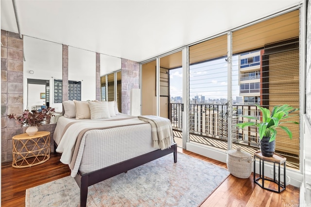 2754 Kuilei St Unit 2002, Honolulu, HI 96826 - bedroom featuring access to exterior, wood finished floors, floor to ceiling windows, and a city view