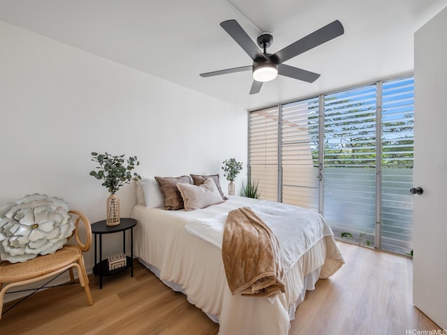 95-65 Waikalani Dr Unit F302, Mililani, HI 96789 - bedroom featuring light wood-type flooring, a wall of windows, access to exterior, and a ceiling fan