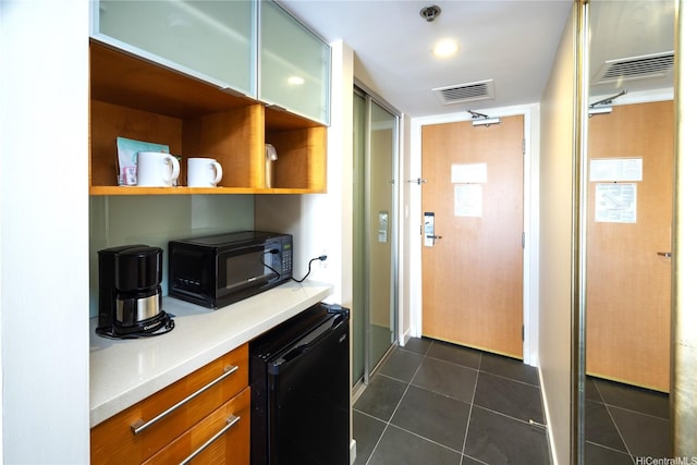 410 Atkinson Dr Unit 1337, Honolulu, HI 96814 - kitchen with black microwave, fridge, light countertops, dark tile patterned floors, and open shelves