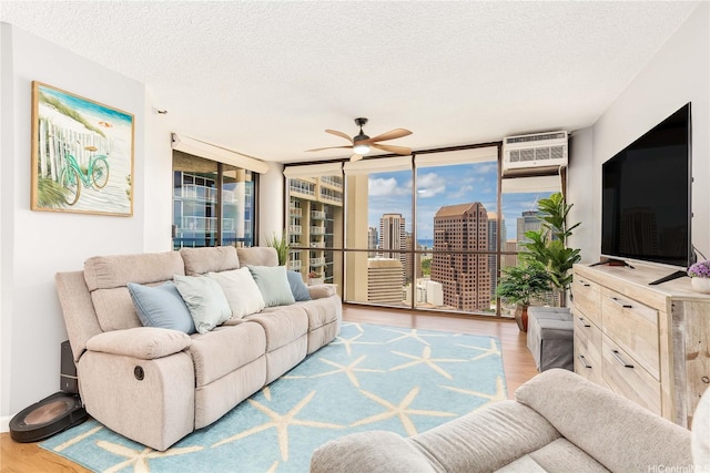 60 N Beretania St Unit 3308, Honolulu, HI 96817 - living room with expansive windows, wood finished floors, plenty of natural light, ceiling fan, and a textured ceiling