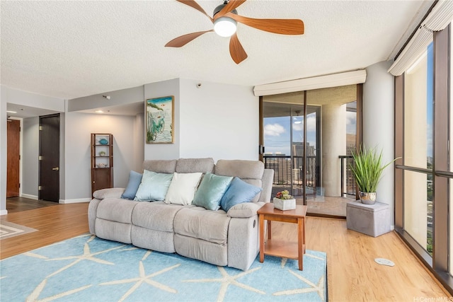 60 N Beretania St Unit 3308, Honolulu, HI 96817 - living room with wood finished floors, a ceiling fan, floor to ceiling windows, a textured ceiling, and baseboards