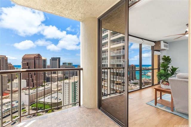 60 N Beretania St Unit 3308, Honolulu, HI 96817 - balcony featuring a city view, a water view, a ceiling fan, and a wall unit AC