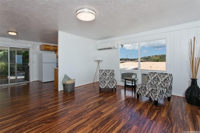 92-675 Wainohia Pl, Kapolei, HI 96707 - sitting room with an AC wall unit, wood finished floors, and a textured ceiling