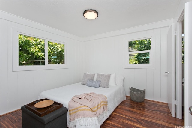 92-675 Wainohia Pl, Kapolei, HI 96707 - bedroom featuring multiple windows, dark wood-style floors, and a decorative wall