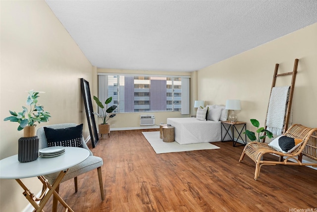 747 Amana St Unit 708, Honolulu, HI 96814 - bedroom featuring wood finished floors, a wall mounted air conditioner, and baseboards