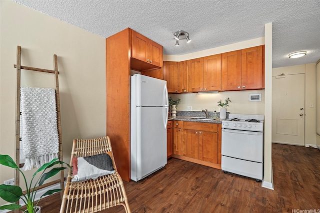 747 Amana St Unit 708, Honolulu, HI 96814 - kitchen with white appliances, a sink, dark wood-style floors, brown cabinets, and a textured ceiling