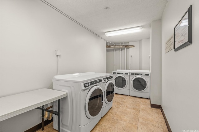 747 Amana St Unit 708, Honolulu, HI 96814 - community laundry room featuring independent washer and dryer, baseboards, and a textured ceiling