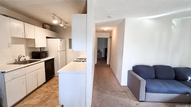91-1062 Mikohu St Unit 4A, Ewa Beach, HI 96706 - kitchen with a sink, black appliances, light countertops, white cabinets, and a textured ceiling