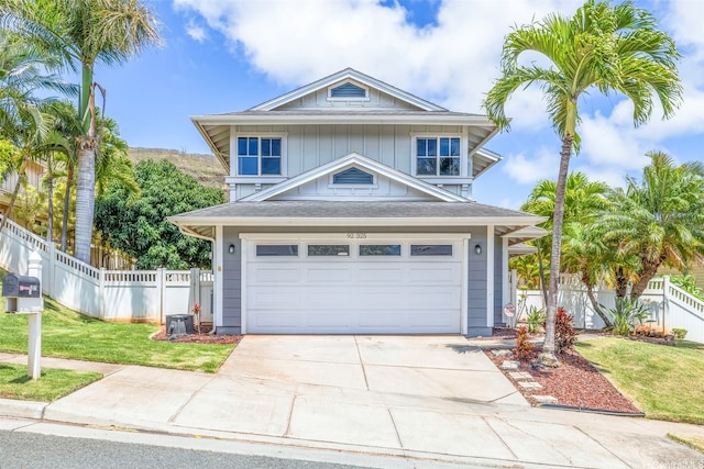 92-325 Palaulau Pl Unit 62, Kapolei, HI 96707 - view of front of property with concrete driveway, board and batten siding, and an attached garage