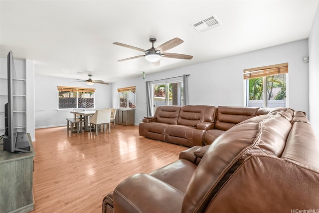 92-325 Palaulau Pl Unit 62, Kapolei, HI 96707 - living room with plenty of natural light, light wood-style floors, a ceiling fan, and baseboards