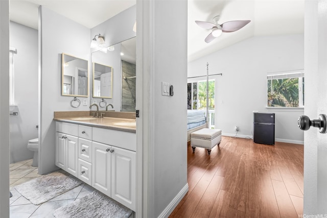 92-325 Palaulau Pl Unit 62, Kapolei, HI 96707 - full bathroom with double vanity, toilet, vaulted ceiling, a ceiling fan, and wood finished floors
