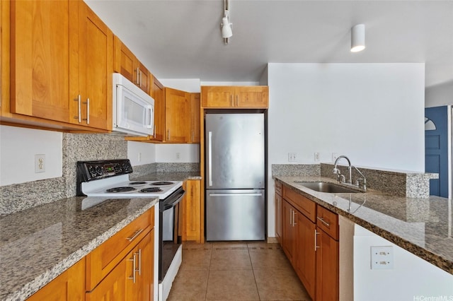 91-1028 Laulauna St Unit 9A, Ewa Beach, HI 96706 - kitchen with white microwave, freestanding refrigerator, electric stove, a sink, and brown cabinets