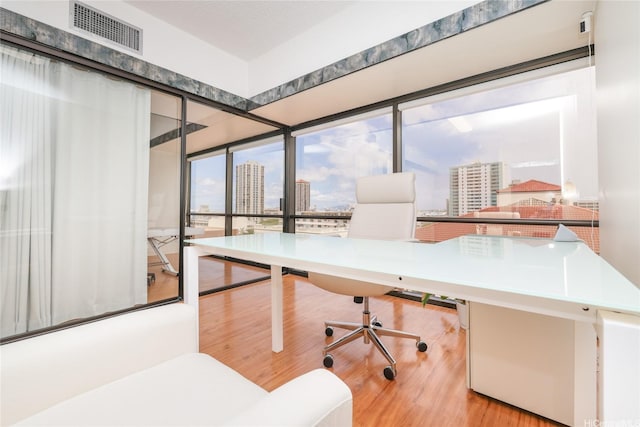1188 Bishop St Unit 910, Honolulu, HI 96813 - home office with a city view and wood finished floors