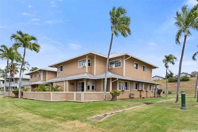 91-1050 Makaaloa St Unit 11E, Ewa Beach, HI 96706 - rear view of house with a yard