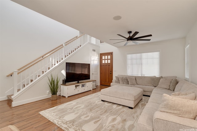 91-1067 Hoomahana St, Ewa Beach, HI 96706 - living area featuring stairway, wood finished floors, ceiling fan, and baseboards