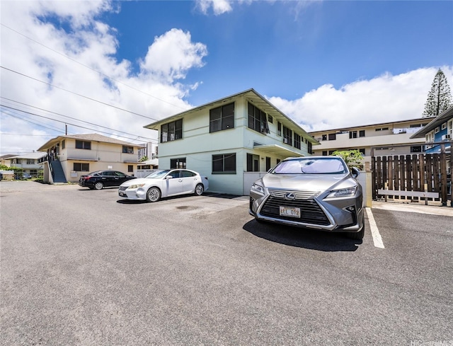 713 Menehune Ln, Honolulu, HI 96826 - view of front of house with uncovered parking and fence