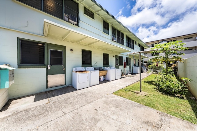 713 Menehune Ln, Honolulu, HI 96826 - view of patio / terrace featuring washer and dryer and fence