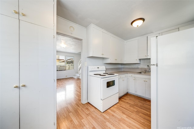 713 Menehune Ln, Honolulu, HI 96826 - kitchen featuring white appliances, a sink, light wood-style floors, light countertops, and white cabinets