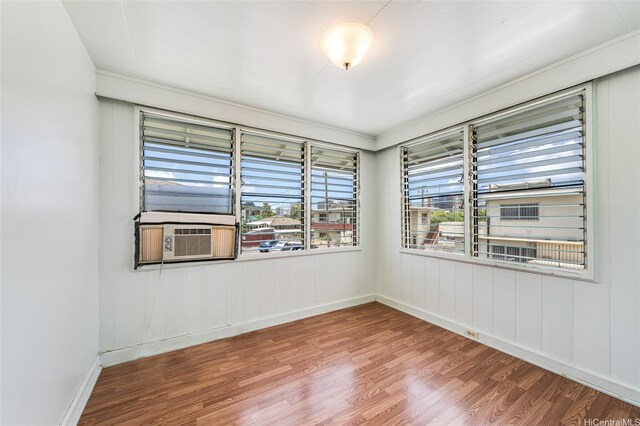 713 Menehune Ln, Honolulu, HI 96826 - unfurnished room featuring cooling unit, wood finished floors, and baseboards