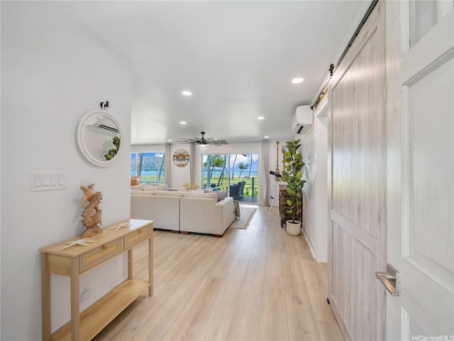 6173 Summer St, Honolulu, HI 96821 - living room featuring a wall mounted air conditioner, recessed lighting, light wood-style flooring, a ceiling fan, and a barn door