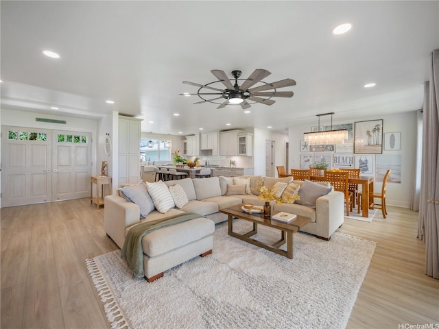 6173 Summer St, Honolulu, HI 96821 - living room featuring ceiling fan, light wood-style floors, recessed lighting, and a chandelier