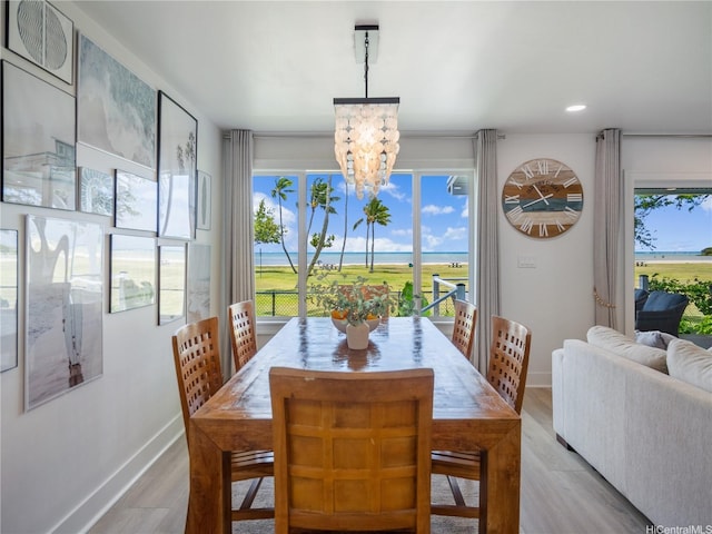 6173 Summer St, Honolulu, HI 96821 - dining room featuring a chandelier, plenty of natural light, light wood-style floors, a water view, and recessed lighting