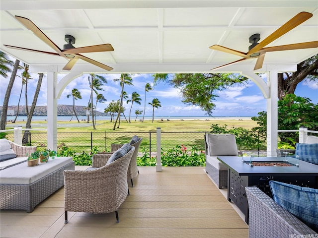 6173 Summer St, Honolulu, HI 96821 - wooden deck with ceiling fan, a fire pit, and a water view