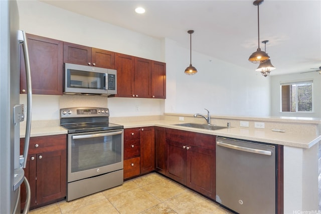 540 Manawai St Unit 402, Kapolei, HI 96707 - kitchen with appliances with stainless steel finishes, a sink, a peninsula, light countertops, and pendant lighting