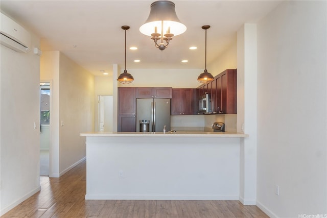 540 Manawai St Unit 402, Kapolei, HI 96707 - kitchen with appliances with stainless steel finishes, a peninsula, light wood finished floors, hanging light fixtures, and recessed lighting