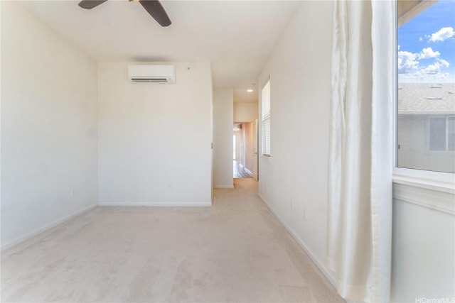 540 Manawai St Unit 402, Kapolei, HI 96707 - spare room featuring an AC wall unit, a ceiling fan, light carpet, and plenty of natural light