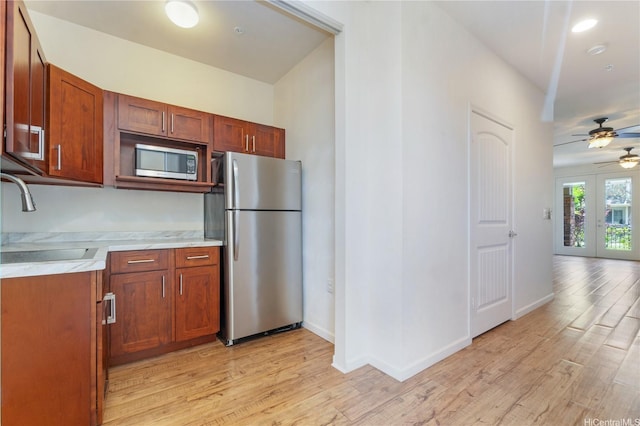 540 Manawai St Unit 402, Kapolei, HI 96707 - kitchen with stainless steel appliances, a sink, light countertops, light wood-style flooring, and ceiling fan