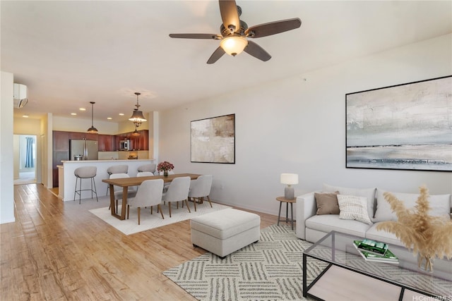 540 Manawai St Unit 402, Kapolei, HI 96707 - living area featuring light wood-style flooring, a ceiling fan, a wall mounted air conditioner, recessed lighting, and baseboards