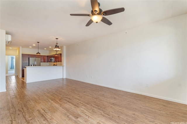 540 Manawai St Unit 402, Kapolei, HI 96707 - unfurnished living room with light wood-style flooring, ceiling fan, baseboards, a wall mounted air conditioner, and recessed lighting