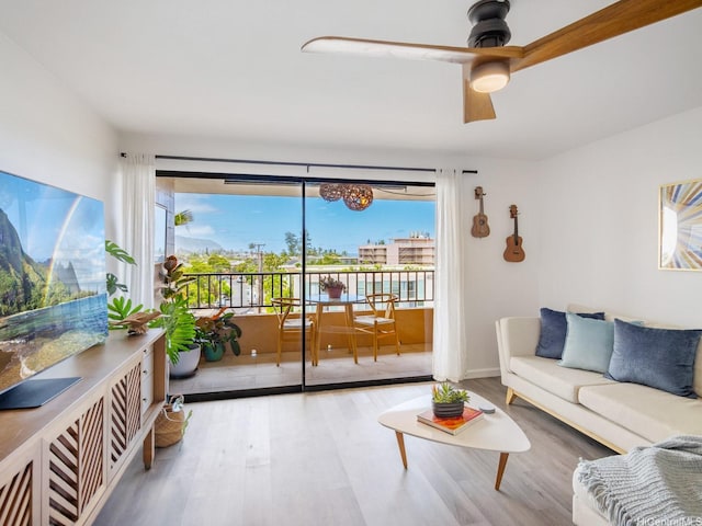 68-024 Apuhihi St Unit W511, Waialua, HI 96791 - living area with wood finished floors, ceiling fan, and baseboards