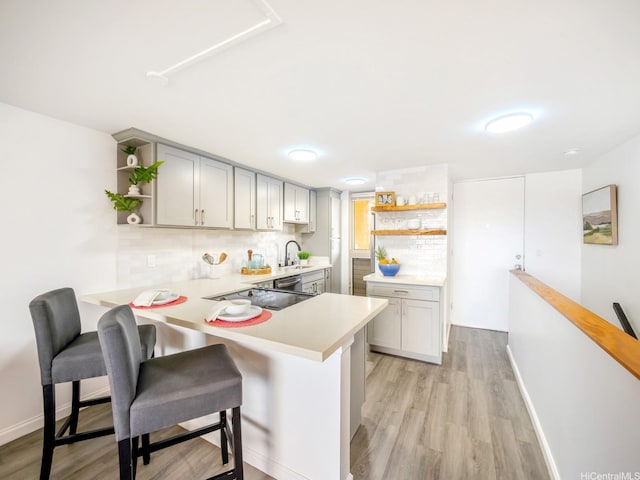 68-024 Apuhihi St Unit W511, Waialua, HI 96791 - kitchen with open shelves, light countertops, a peninsula, and a breakfast bar