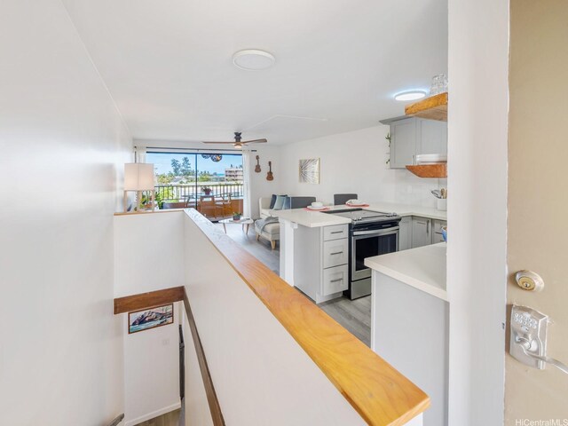 68-024 Apuhihi St Unit W511, Waialua, HI 96791 - kitchen featuring stainless steel electric range oven, light countertops, ceiling fan, gray cabinets, and light wood-style floors