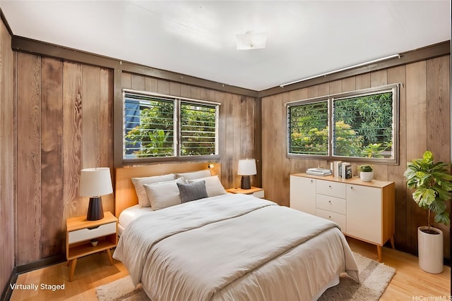 1916 Huina St, Honolulu, HI 96817 - bedroom with wooden walls and light wood-style flooring
