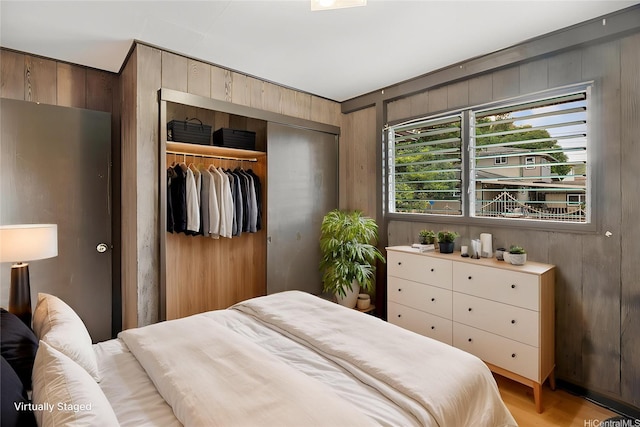 1916 Huina St, Honolulu, HI 96817 - bedroom with wooden walls, a closet, and light wood-type flooring