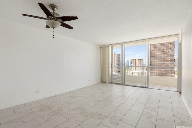 1515 Ward Ave Unit 304, Honolulu, HI 96822 - unfurnished room featuring a wall of windows, ceiling fan, baseboards, and a city view