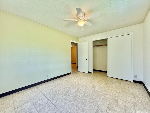 61-286 Kamehameha Hwy, Haleiwa, HI 96712 - unfurnished bedroom featuring baseboards, stone finish floors, a closet, ceiling fan, and a textured ceiling