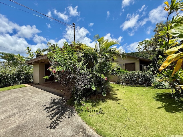 61-286 Kamehameha Hwy, Haleiwa, HI 96712 - view of front of house with a front lawn, stucco siding, and concrete driveway