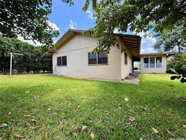61-286 Kamehameha Hwy, Haleiwa, HI 96712 - view of home's exterior with a lawn and concrete block siding