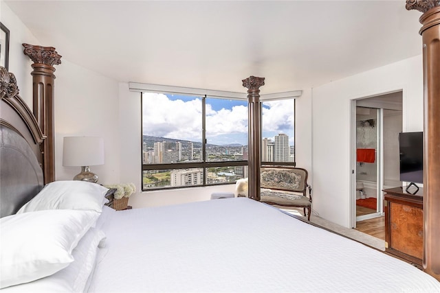 1910 Ala Moana Blvd Unit 35C, Honolulu, HI 96815 - bedroom featuring wood finished floors and connected bathroom