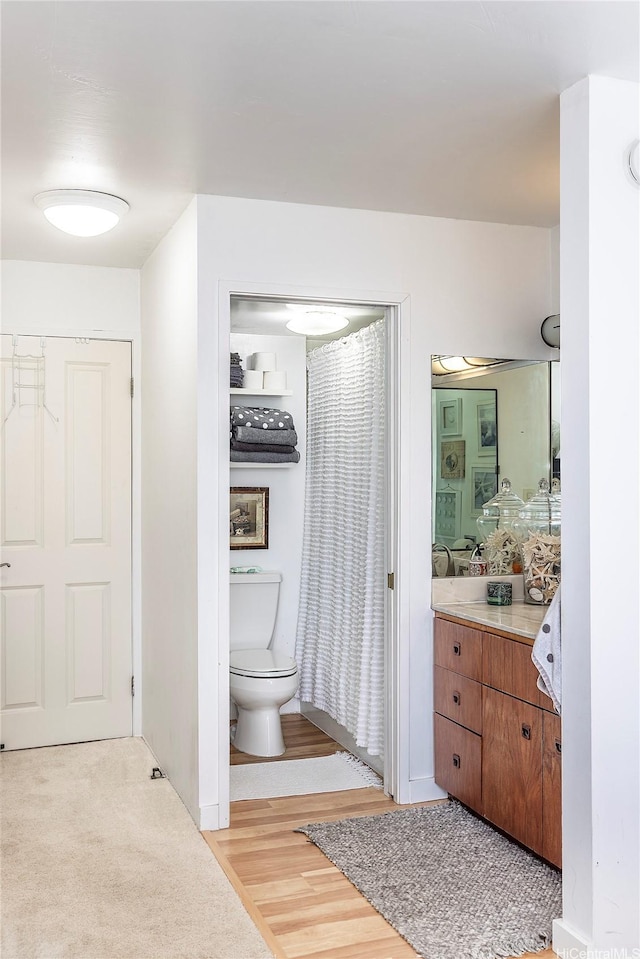 1910 Ala Moana Blvd Unit 35C, Honolulu, HI 96815 - bathroom featuring vanity, toilet, and wood finished floors