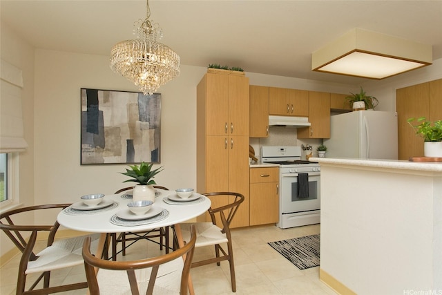 98-1970-A Kaahumanu St Unit 128, Pearl City, HI 96782 - kitchen with white appliances, under cabinet range hood, a chandelier, light countertops, and pendant lighting