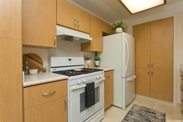98-1970-A Kaahumanu St Unit 128, Pearl City, HI 96782 - kitchen with under cabinet range hood, white appliances, light countertops, and light tile patterned floors