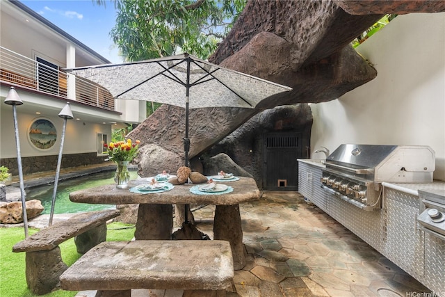 view of patio featuring area for grilling, grilling area, and a balcony