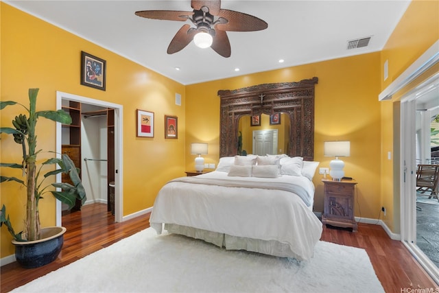 bedroom featuring wood finished floors, baseboards, and a ceiling fan