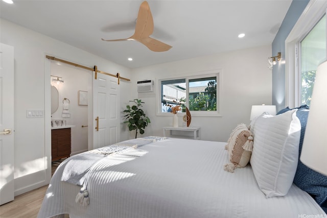 92-370 Malahuna Pl, Kapolei, HI 96707 - bedroom with a barn door, wood finished floors, recessed lighting, ceiling fan, and an AC wall unit